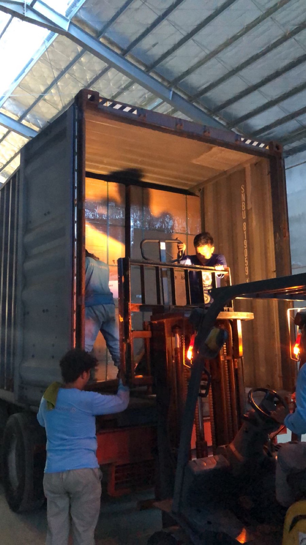 Forklift unloading cargo from a shipping container